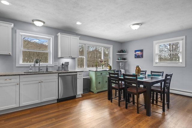 kitchen with dark wood-style floors, white cabinetry, dishwasher, and a sink