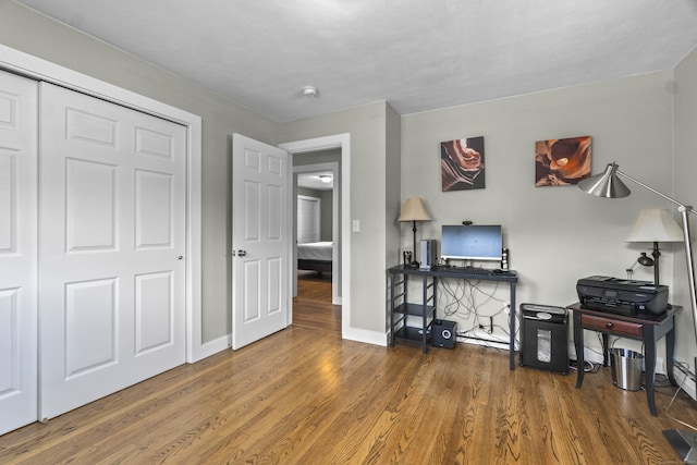 office area featuring wood finished floors and baseboards