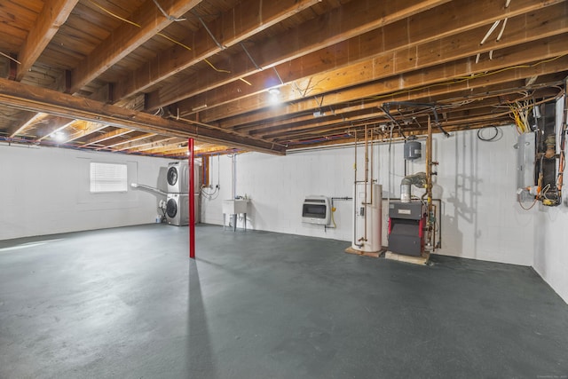 basement featuring electric panel, a heating unit, gas water heater, heating unit, and a sink