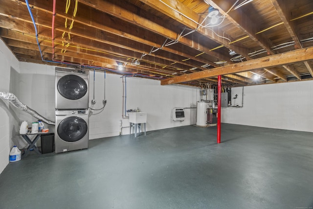 unfinished basement with concrete block wall, electric panel, stacked washer / dryer, heating unit, and water heater