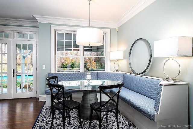 dining space with baseboards, breakfast area, ornamental molding, dark wood-style flooring, and french doors