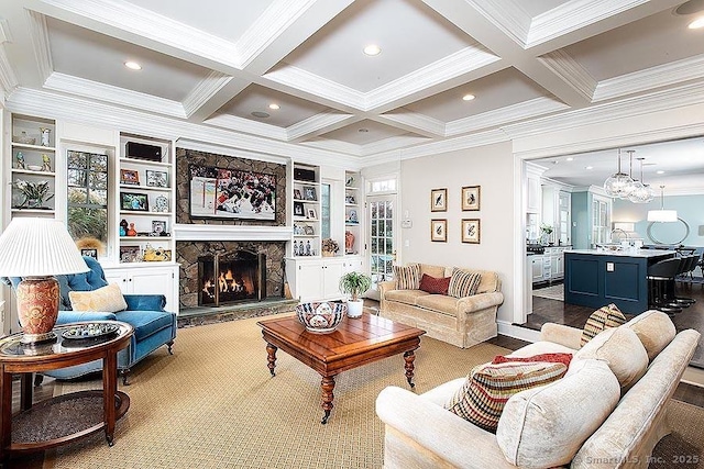 living area with ornamental molding, coffered ceiling, beam ceiling, and a stone fireplace