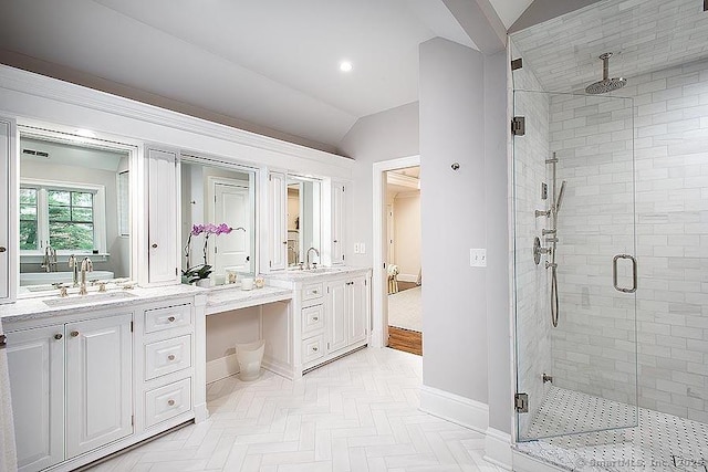 bathroom featuring baseboards, vaulted ceiling, vanity, a shower stall, and recessed lighting