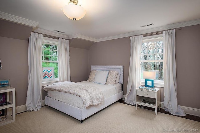 carpeted bedroom with lofted ceiling, ornamental molding, visible vents, and baseboards