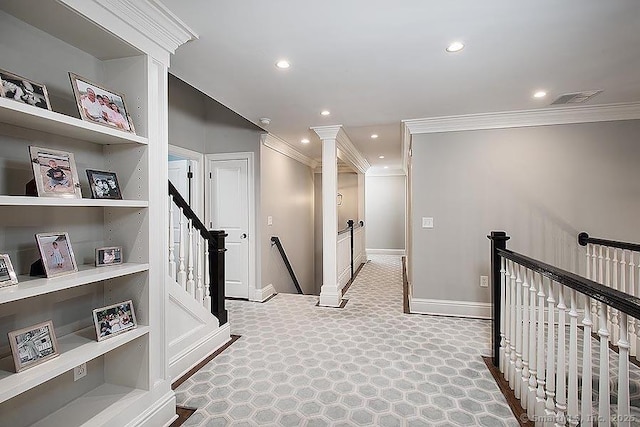 corridor with visible vents, ornamental molding, and an upstairs landing