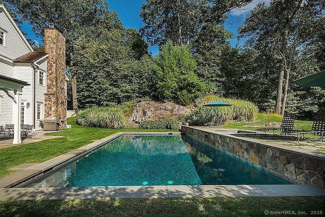 outdoor pool with a yard