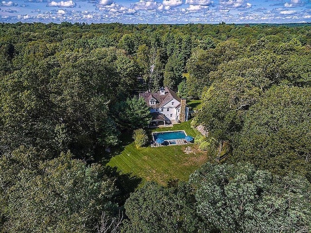 drone / aerial view featuring a forest view