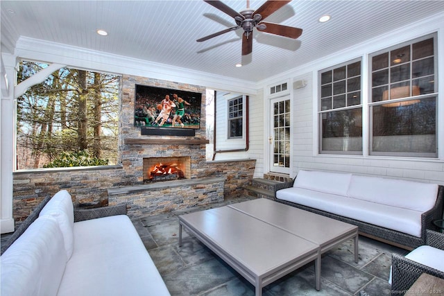 view of patio / terrace with an outdoor stone fireplace and a ceiling fan