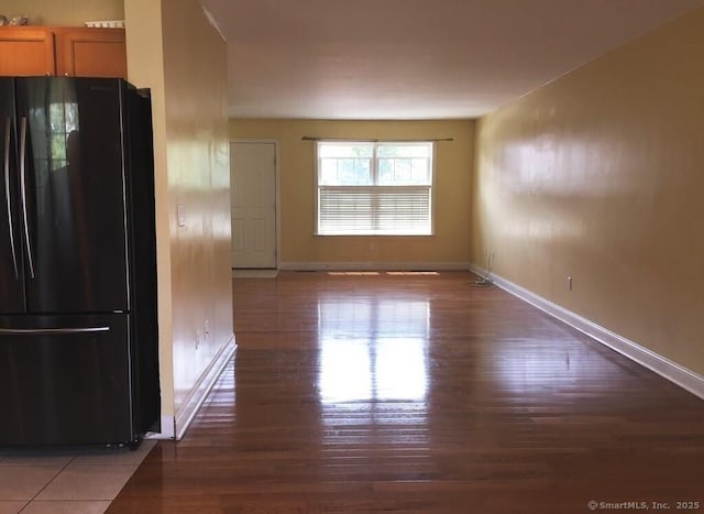 interior space featuring baseboards and wood finished floors