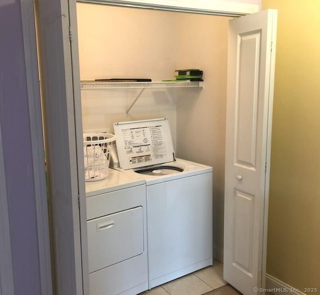 laundry area featuring light tile patterned floors, laundry area, and washing machine and dryer