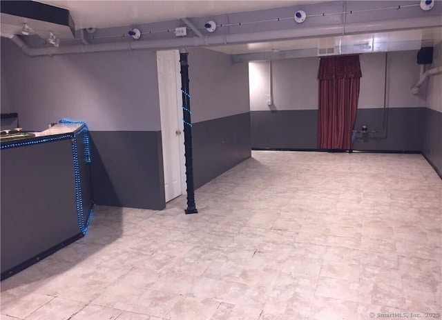 finished basement with tile patterned floors