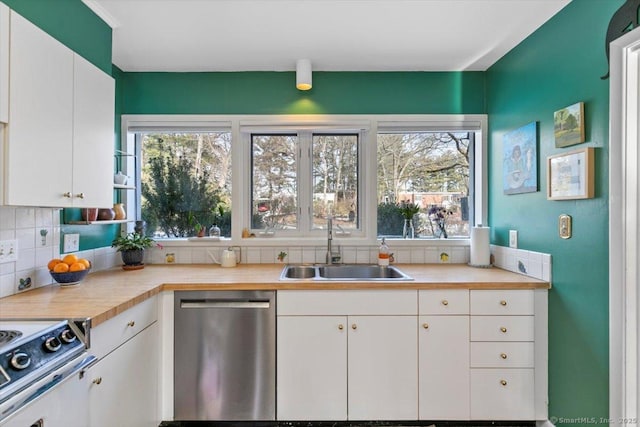 kitchen with a sink, white cabinets, light countertops, decorative backsplash, and dishwasher