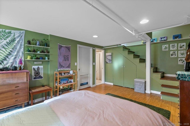 bedroom with baseboards, recessed lighting, and light wood-style floors