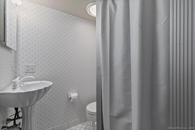 bathroom featuring toilet and tile patterned floors