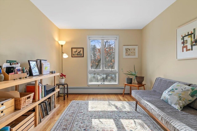 living area with light wood finished floors and a baseboard radiator