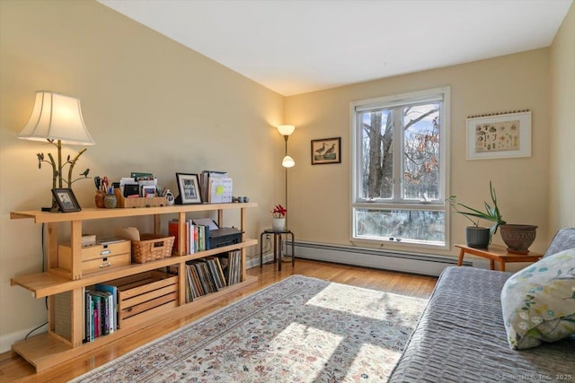 sitting room featuring light wood-style flooring and baseboard heating