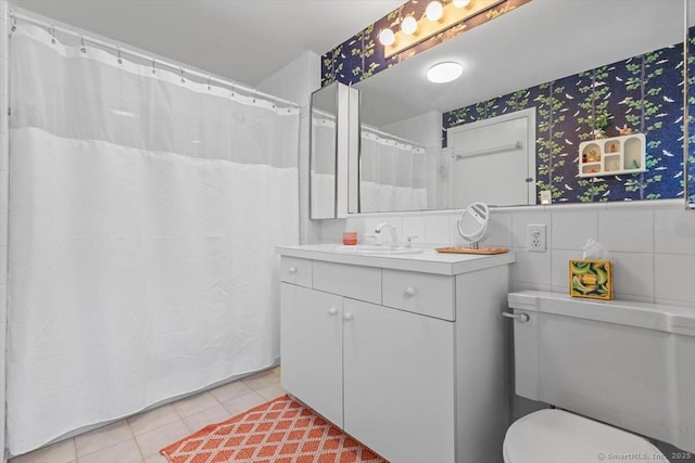 bathroom featuring toilet, wallpapered walls, vanity, and tile patterned floors