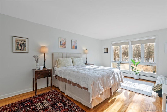 bedroom featuring wood finished floors and baseboards