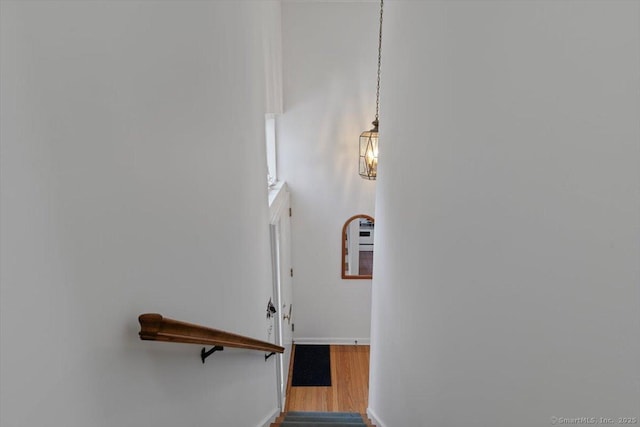 stairs featuring baseboards and wood finished floors