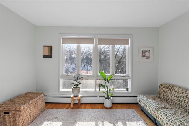 sitting room with a baseboard radiator and light wood-style flooring