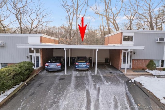 view of parking / parking lot with a wall mounted air conditioner