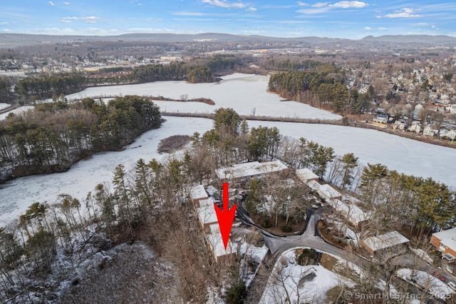 snowy aerial view featuring a mountain view