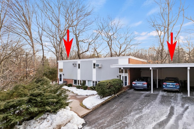 view of front of property featuring brick siding and driveway