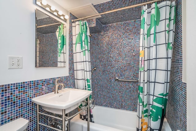 bathroom with shower / tub combo, tile walls, and toilet