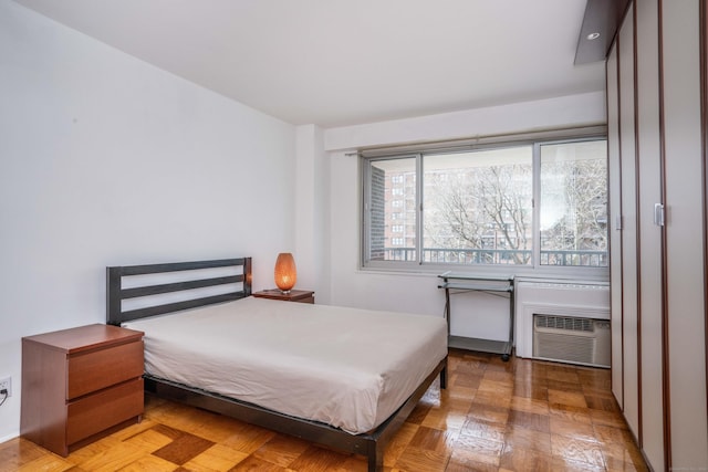 bedroom with an AC wall unit