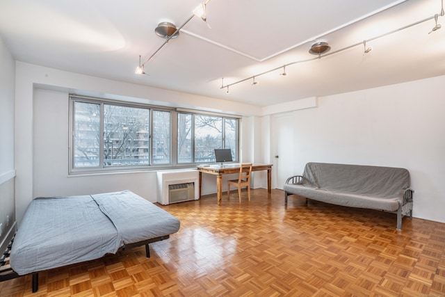 interior space with an AC wall unit and track lighting