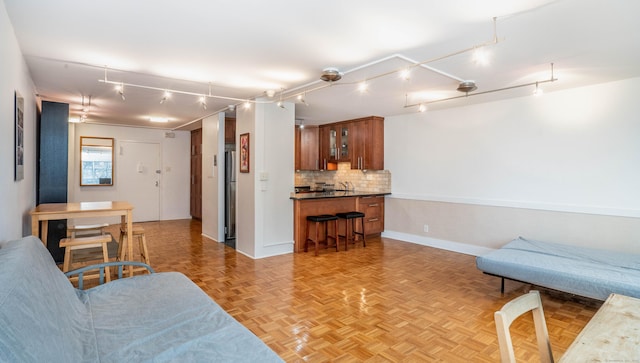 living area featuring baseboards