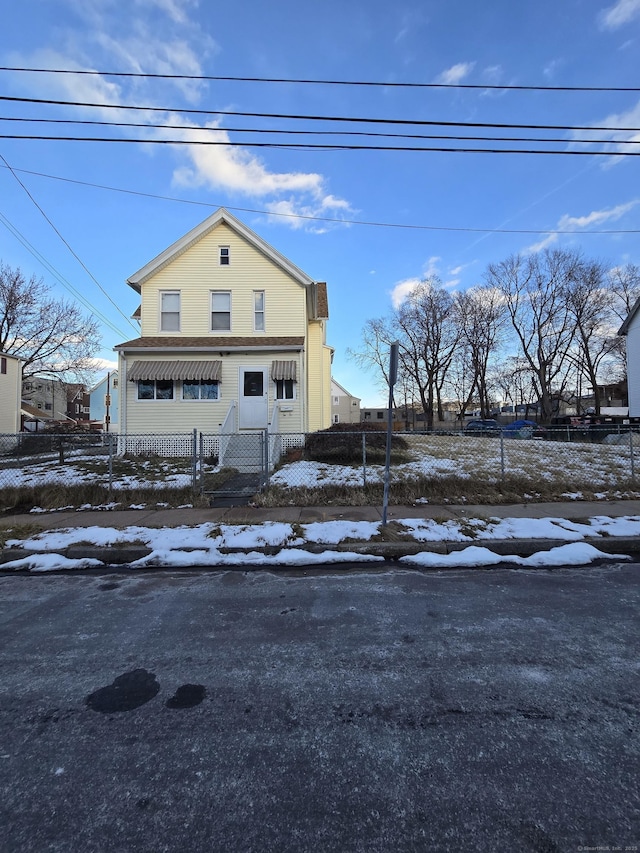 view of front of property featuring fence