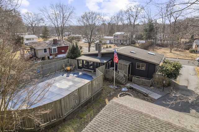 view of pool with a patio area, a residential view, fence, and a wooden deck