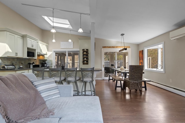 living room featuring lofted ceiling with skylight, a wall mounted AC, and dark wood finished floors