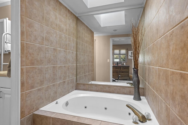 bathroom featuring ornamental molding, a tub with jets, a skylight, and tile walls