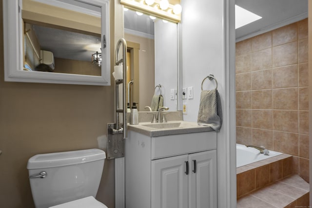 bathroom featuring crown molding, tiled bath, toilet, vanity, and tile patterned flooring