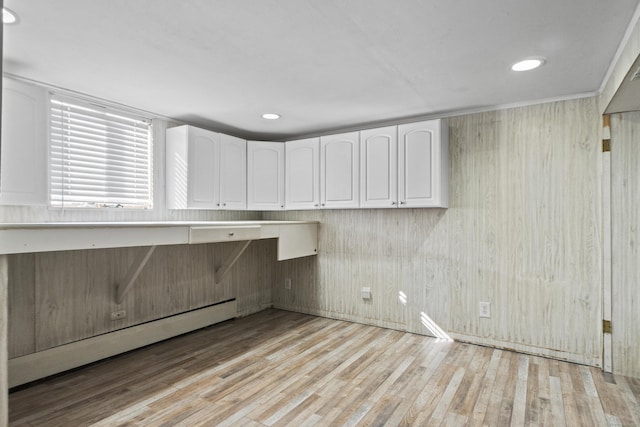 interior space featuring light wood-style floors, recessed lighting, white cabinetry, and baseboard heating