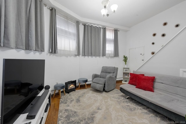 sitting room with a baseboard radiator and wood finished floors