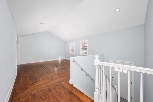 hallway featuring parquet floors, recessed lighting, vaulted ceiling, an upstairs landing, and baseboards