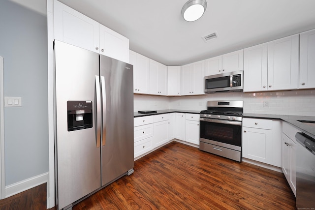 kitchen with appliances with stainless steel finishes, visible vents, and white cabinets