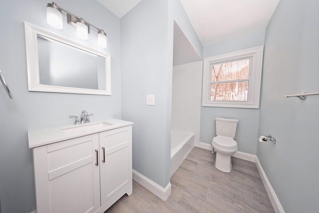 full bathroom featuring baseboards, vanity, toilet, and wood finished floors