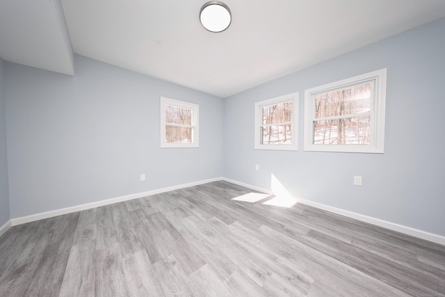 unfurnished room with light wood-style floors and baseboards