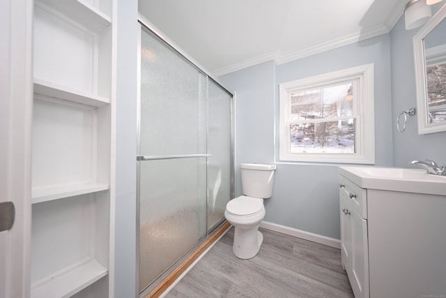 full bath with a stall shower, baseboards, crown molding, and wood finished floors