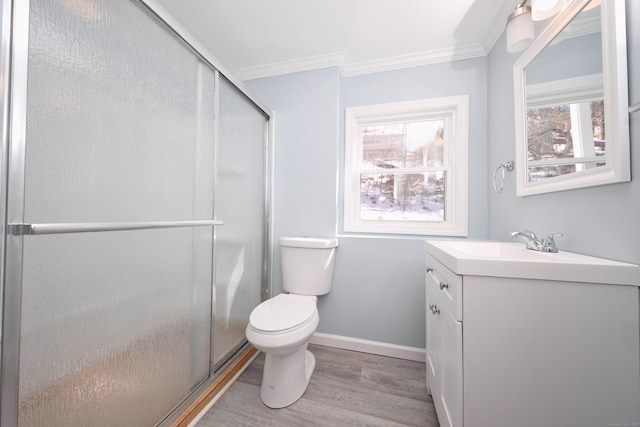 bathroom featuring ornamental molding, a stall shower, and baseboards