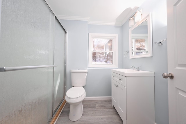 full bathroom with a stall shower, toilet, ornamental molding, wood finished floors, and vanity