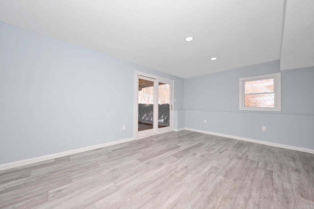 spare room featuring light wood-type flooring, baseboards, and recessed lighting