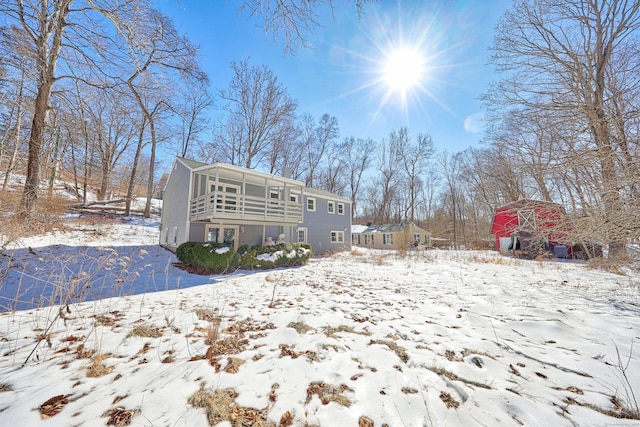 snow covered house with a sunroom