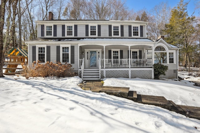 view of front of home with covered porch and a chimney