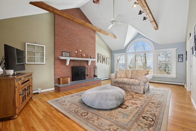 living room with a baseboard radiator, a brick fireplace, ceiling fan, and light wood finished floors