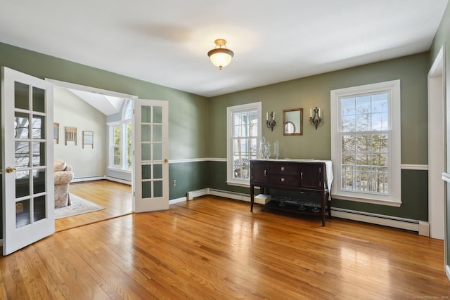 interior space with hardwood / wood-style flooring, plenty of natural light, and french doors